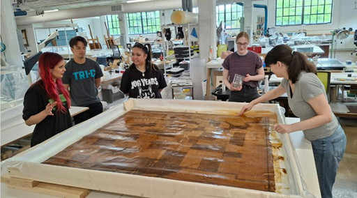 Students around an art conservation lab table