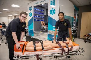 Two EMT students with patient on stretcher