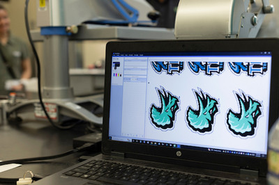 Stomp on computer screen with printing press in the background
