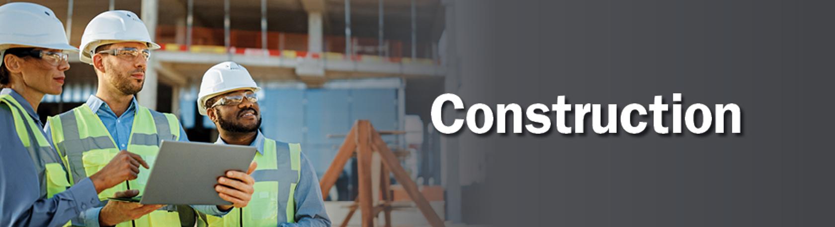 Workforce training banner image with group of construction workers looking at a clipboard and pointing with the words construction on a gray gradient background. 