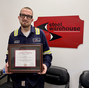 student standing with journey-level certificate Brendon jasko