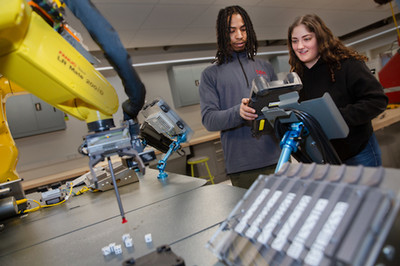 faculty and student working on machine