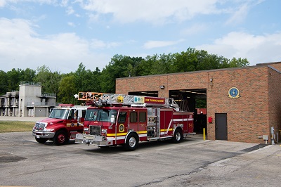 Fire engines parked outside of fire house