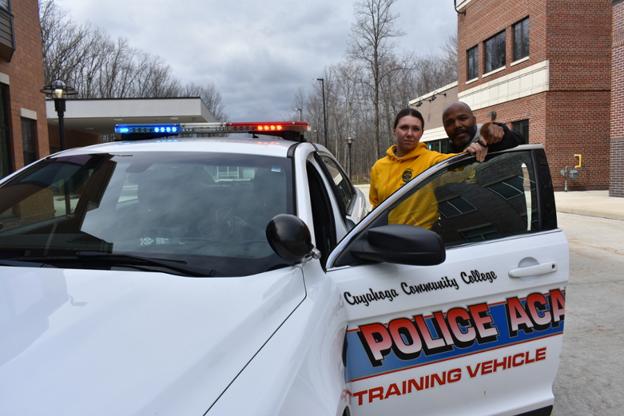 Police Academy Cadet with Instructor standing at car