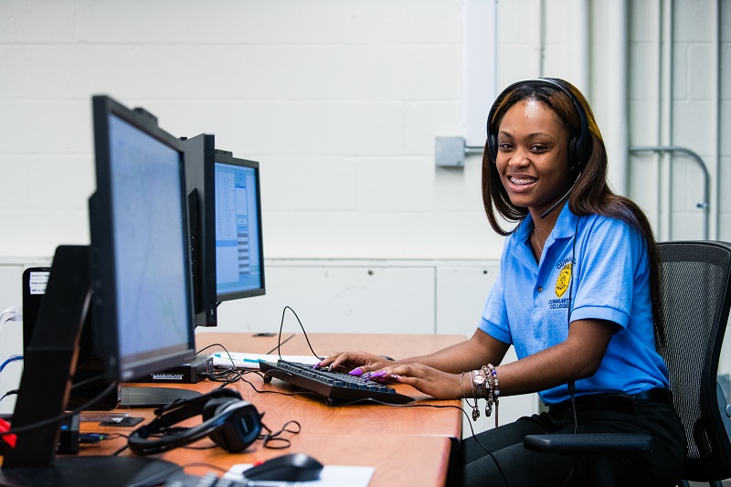 Dispatch student sitting in front of two computer screens