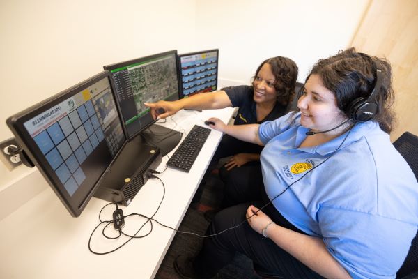 Female dispatcher in front of computers