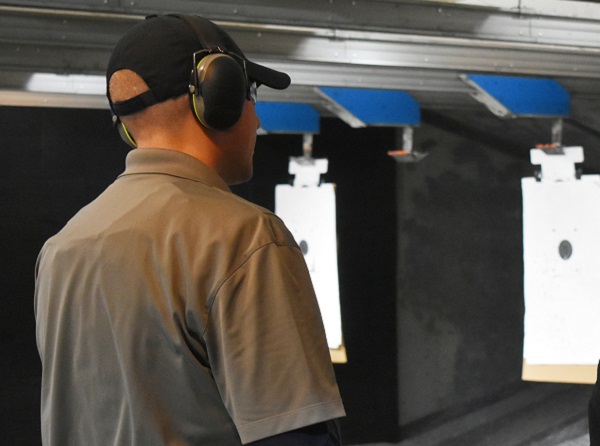 Instructor and student standing in firing range talking