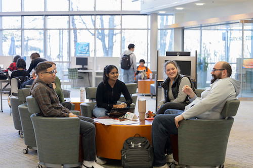 group of smiling students in the campus atrium